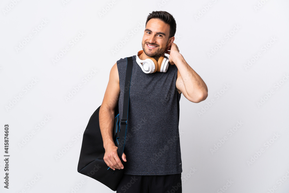 Wall mural young sport man with sport bag isolated on white background laughing