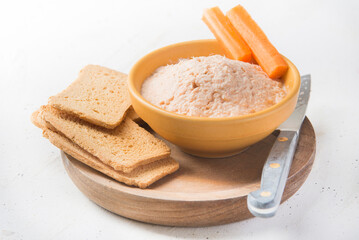 salmon pate with red caviar served, sliced bread and parrot.