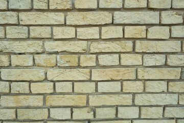 Peeled old brick wall. Brick yellow background.