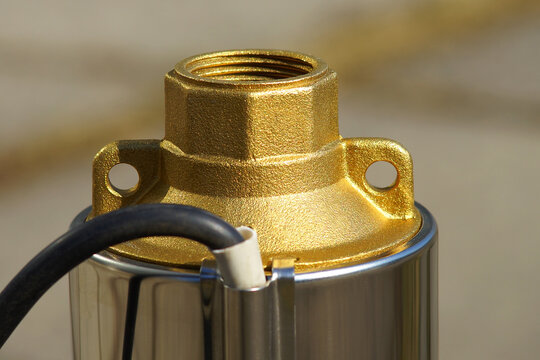 The top of the well pump with black cable close up. The top of the well pump with lugs for fastening with a cable. The outlet thread of the downhole pump.