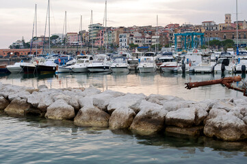 The village of Marina di Camerota with its port at sunset. Waterfront.