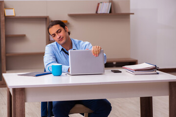 Fototapeta premium Young male employee working from home during pandemic