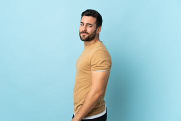 Young handsome man with beard over isolated background . Portrait