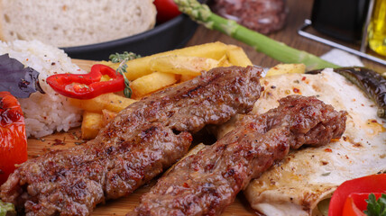 grilled kebab with fried potatoes and rice
