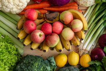 Many healthy organic vegetables and fruits are sitting on the table.