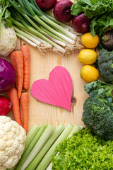 To take care of your diet, consuming too many vegetables to protect your heart. Heart and various vegetables on the table.