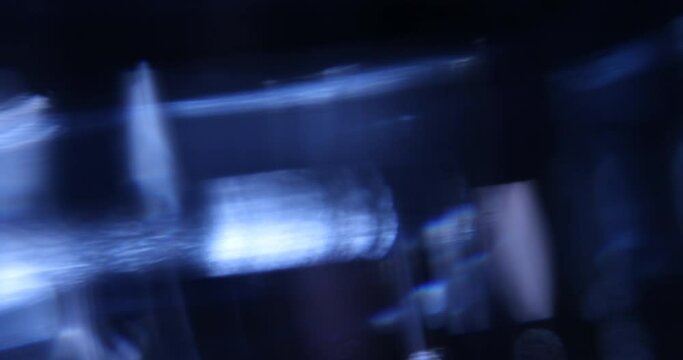 Multicolored moving light leaks 4k footage on black background. Studio lens flare for overlays. Bokeh effect
