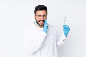 Dentist man holding tools isolated on white background whispering something