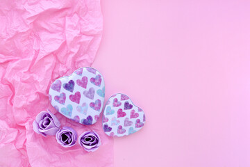 Valentines Day background. Two boxes with hearts on pink paper background with space for your text