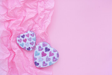 Valentines Day background. Two boxes with hearts on pink paper background with space for your text