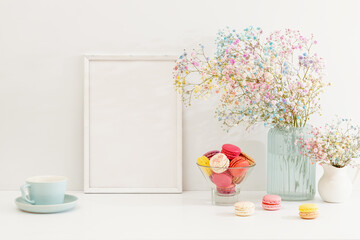Sweet colorful macarons and flower gypsophila on table.