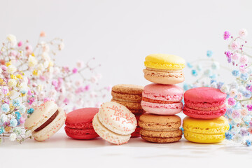 Colorful macaroons with flowers.