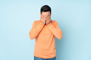 Caucasian handsome man with tired and sick expression over isolated blue background