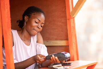 nigerian lady using a pos machine