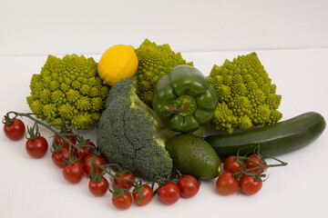 fresh vegetable, romanesco, pepper, zucchini, avocado, cherry tomato and lemon free space in your text, on a isolated background
