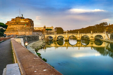 Red wall of St. Angelo Bridge, Tiber River reflection, Rome, Italy. Bridge first built by Emperor...