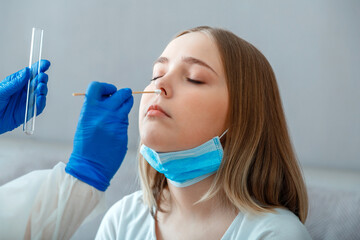 Nurse take saliva sample through nose with cotton swab check coronavirus covid 19 test. Diagnostics...
