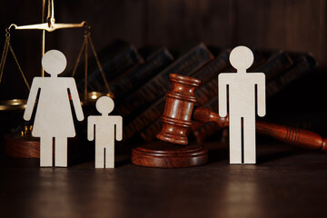 Dad and mom with child figures with judge gavel. Divorce concept.