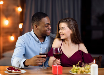 Affectionate Multicultural Couple Enjoying Date In Restaurant, Celebrating Valentine's Day Together