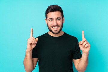 Caucasian handsome man isolated on blue background pointing up a great idea