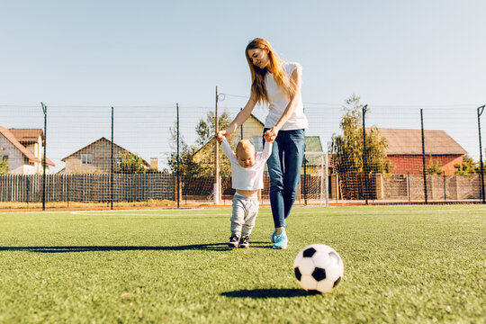 Family, Mom And Child Playing Soccer On The Soccer Field