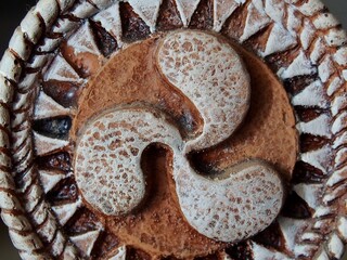 The triskelion, triskelion or triskele is a motif consisting of three joined spirals, three bent human legs or three lines extended or bent from the center of the symbol.