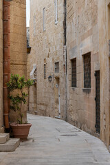 Fototapeta na wymiar Europe, Malta, Mdina. Typical historic narrow street lined with limestone buildings.