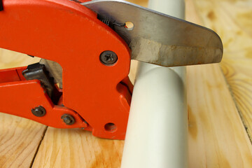 scissors cut a plastic water pipe