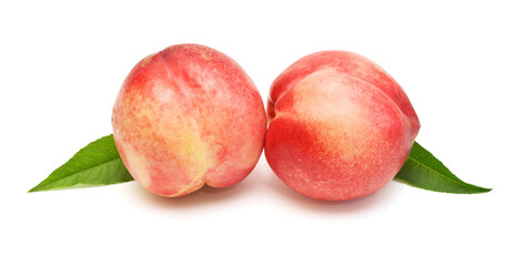 Heap of whole peaches with leaves isolated on white background