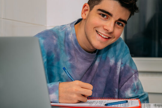 student at the table writing and studying