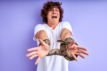 snake tied man's hands. man stand crying by fear, thinks how to get free from the shackles of the...