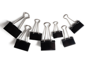 Black paper clips for paper documents clamping. Office metal foldback braces. Stainless steel...