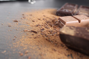 Background International Chocolate Day milky dark chocolate on a grey black background with a copyspace place for text