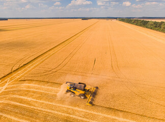 Harvesting machine working in the field. Top view from the drone Combine harvester agricultural machine ride in the field