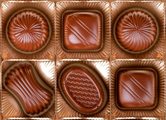 chocolates lie in cells of boxes in a row top view