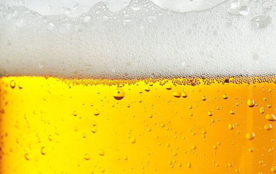 Beer background with bubble froth texture foam pouring alcohol soda in glass happy celebration party holiday new year concept object design