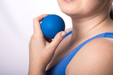  A girl with long hair goes in for sports at home and does massage with a myofascial ball. Suitable for sports massage roller.