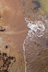 Sandy beach and waves. View from above.