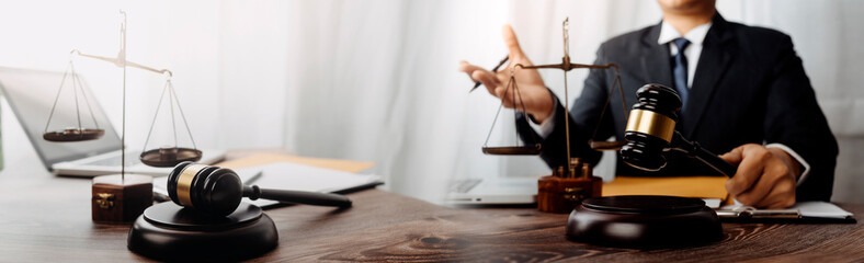 Business and lawyers discussing contract papers with brass scale on desk in office. Law, legal services, advice, justice and law concept picture with film grain effect