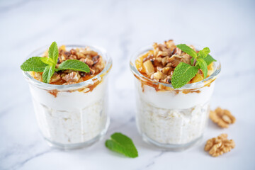 Greek yogurt millet caramelized apple walnuts parfait in a glass