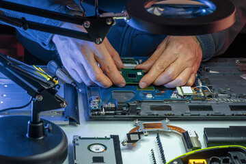IT specialist replacing details in computer repair workshop