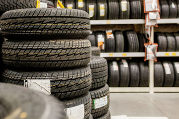Car tires and wheels at warehouse in tire store.