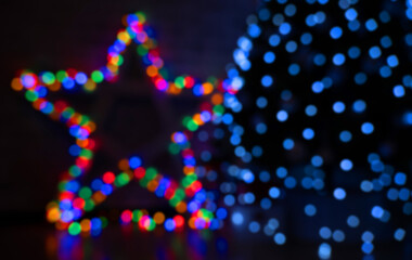 multicolored festive bokeh out of focus in the shape of a star, suitable for text in the foreground