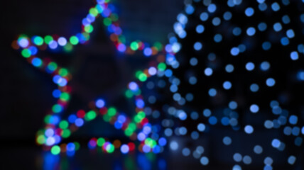 multicolored festive bokeh out of focus in the shape of a star, suitable for text in the foreground