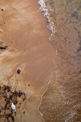 Sandy beach and waves. View from above.