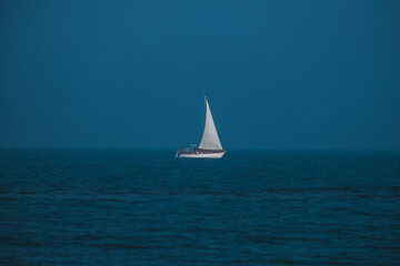 Isolated sailboat in the middle of the sea