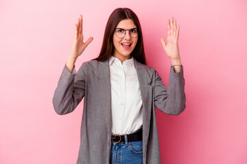 Young caucasian business woman isolated on pink background receiving a pleasant surprise, excited...