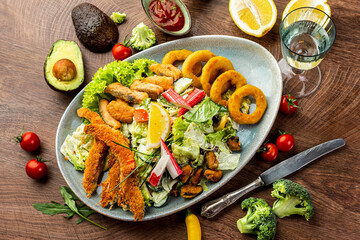 Seafood and vegetable salad. Shrimps, mussels, squid rings