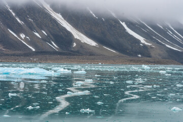 Arctic Norway, Svalbard, Spitsbergen. The mountains of northern Spitsbergen exude a brooding ambience with rocks, ice, and water.