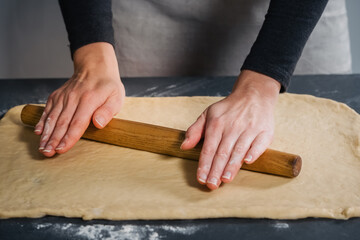 Woman rolling out the dough for buns